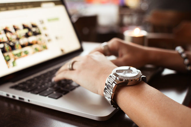 girl-with-watches-typing-on-macbook