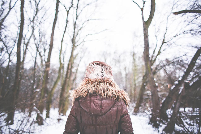 Girl walking snowy forest