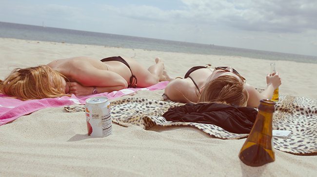 two girl are lying in the sun